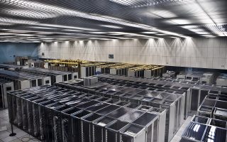 Rows of server racks in a large computer center